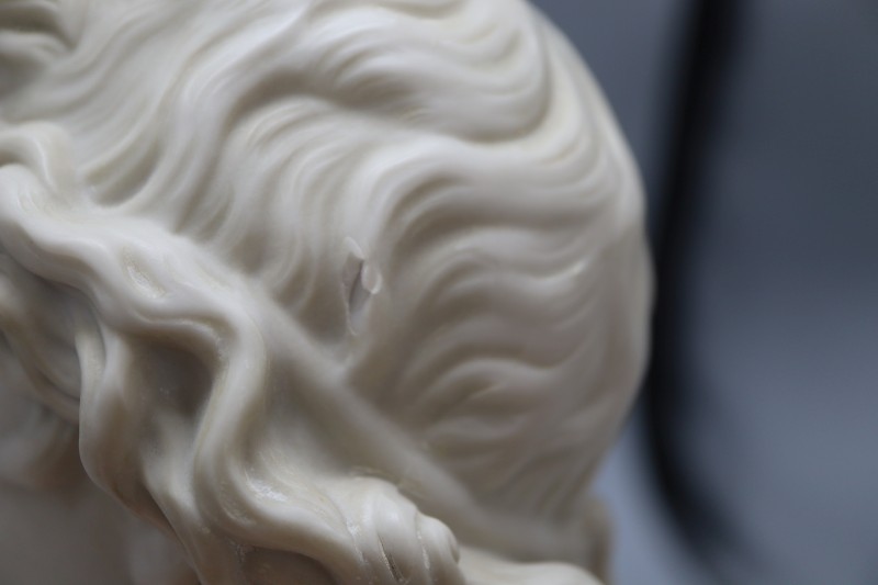 A resin marble bust of Apollo, height 34cm